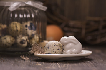 Glass jar with quail eggs. Easter greeting card. Spring concept. Toned image. Selective focus