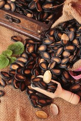 Watermelon seed of delicious on wood background.