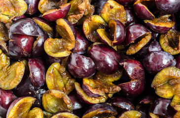 Pitted prune plums background.