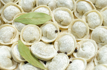 Meat dumplings russian pelmeni with bay leaf.  Close up