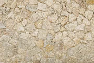 Old beige stone wall background texture