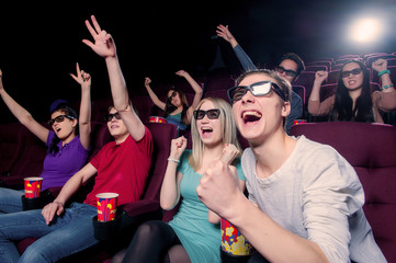 People in the cinema wearing 3d glasses