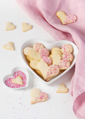 Homemade heart shaped cookies with white chocolate and pink sugar sprinkles. Valentines day.