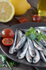 fresh anchovies, placed on a wooden table