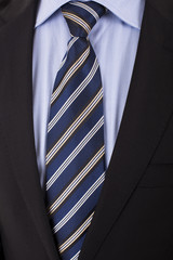 Close up of businessman wearing a tie, shirt, and suit