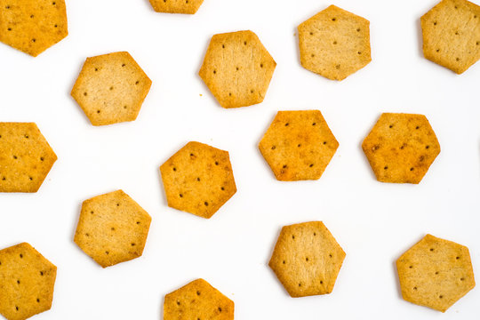 Yellow, hexagon crackers isolated on white background. Food texture.