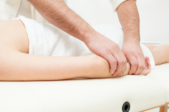 Close-up Of Male Hands Getting A Woman Forearm Massage