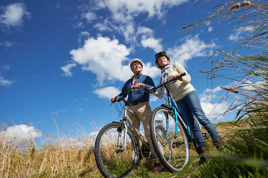 Senior Couple Cycling Through Countryside Together