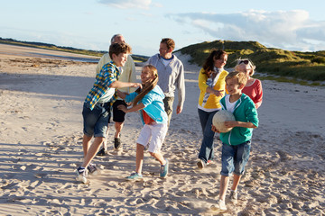 Extended Family Group Walking Along Beach