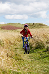 Girl Riding Bike Through Countryside