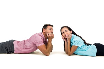 Obraz premium Young couple laying on floor looking away