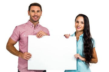 Smiling couple showing blank sheet 