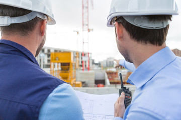 Worker and architect watching some details on a construction