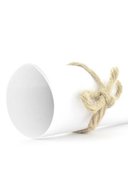 Handmade natural string knot tied on white paper scroll isolated