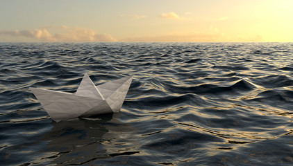 Origami paper boat sailing on blue water