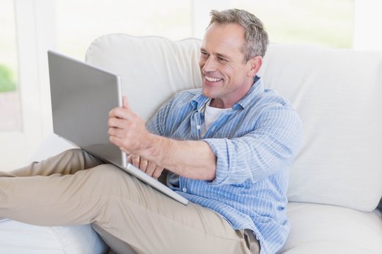 Happy man using laptop