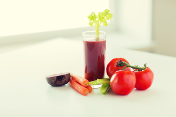 close up of fresh juice and vegetables on table