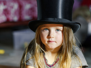 Cute little girl in black top hat