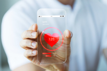 close up of hand with heart rate on smartphone