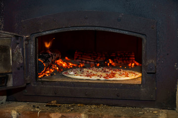 Pizza cooking in natural vintage stove
