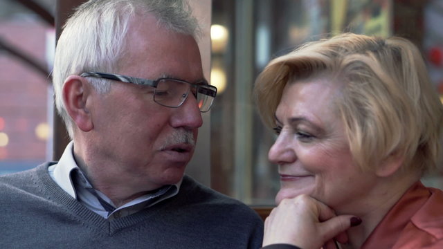 Happy, Middle Aged Couple In Love Talking In Cafe
