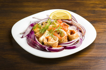 Herring rolls in oil and onions