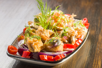 Herring rolls in oil and onions