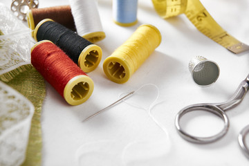 Sewing tools on fabric background elevated view