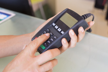 Closeup hands woman swipe through terminal, security code