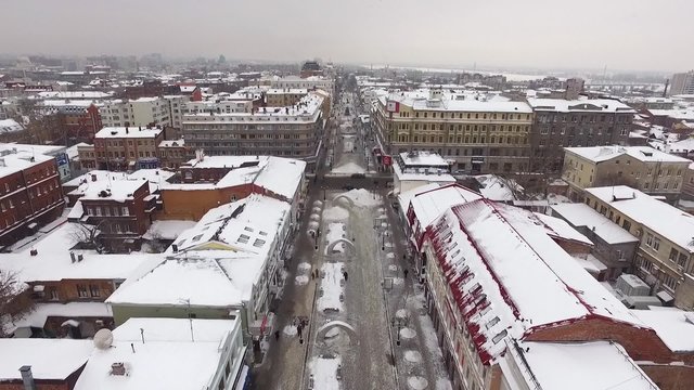 aerial winter city drone flies over street