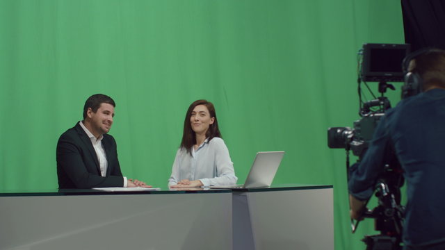 Businessman in a suit is pushing a virtual interactive wall on a mock-up green screen in the background. Shot on RED Cinema Camera.