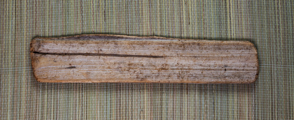 Wooden plank / timber wood / driftwood on straw mat - panorama.