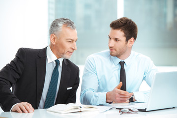 Fototapeta premium Aged and young businessmen having meeting