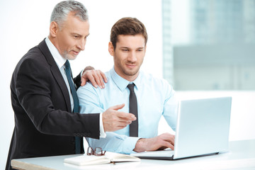 Aged and young businessmen having meeting