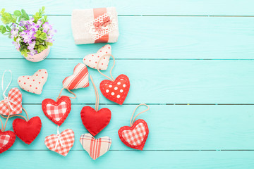 Hearts, flowers and gift on blue wooden table. Copy space and top view