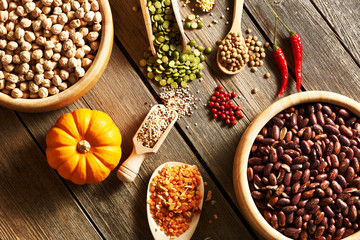 Bowls and spoons of various legumes