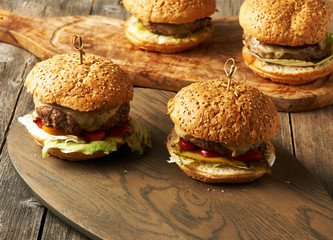 Home made cheeseburgers on wooden table