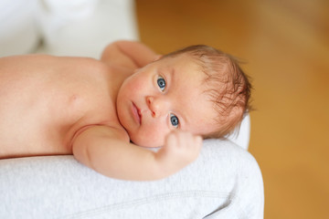 One month old newborn baby with mother