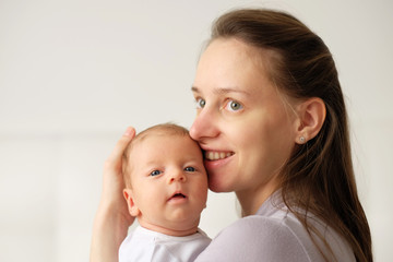 One month old newborn baby with mother