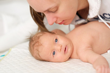 One month old newborn baby with mother