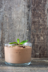 Fresh chocolate mousse on a rustic wood table
