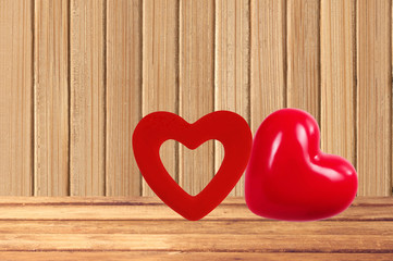 Red hearts on the wooden background