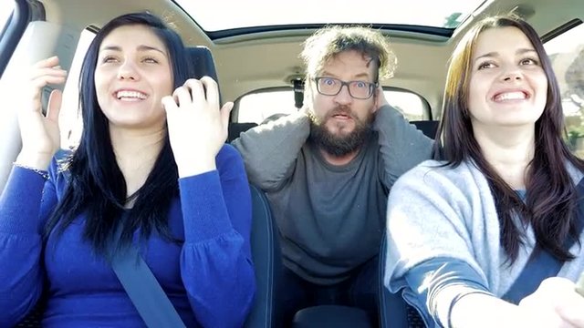 Three people driving car screaming scared about getting into accident