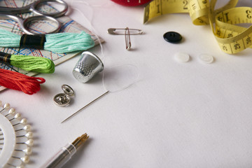Composition tools for embroidery on white fabric elevated view