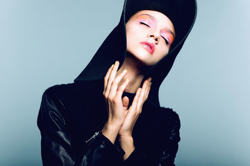 Portrait of beautiful girl in hat, posing in studio