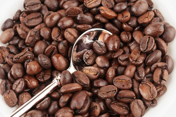 Brown roasted coffee bean and tea spoon