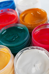 Several plastic bottles with colored gouache.
