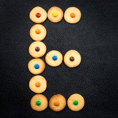 Cookie alphabet - Homemade child cookies - E letter of the alphabet - black stone background