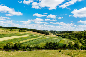 beautiful summer landscape of river in the valley, fields and fo