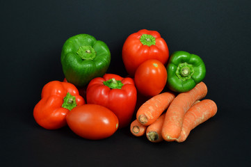 A pepper Assortment with tomato and carrot.